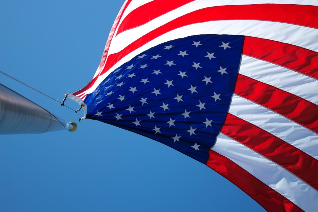 American scholarships. USA flag waving under blue sky