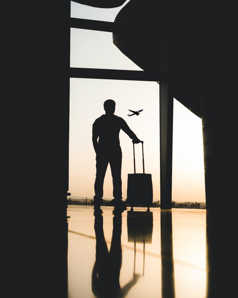 Nepal. silhouette of man holding luggage inside airport