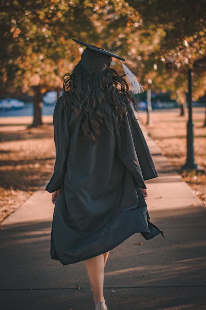 Scholarships in Sydney. Woman in Black Long Sleeve Dress Standing on Brown Concrete Pathway