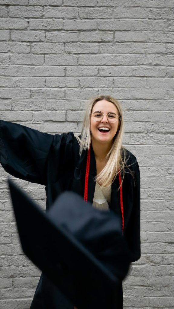 USA. woman in black academic gown smiling